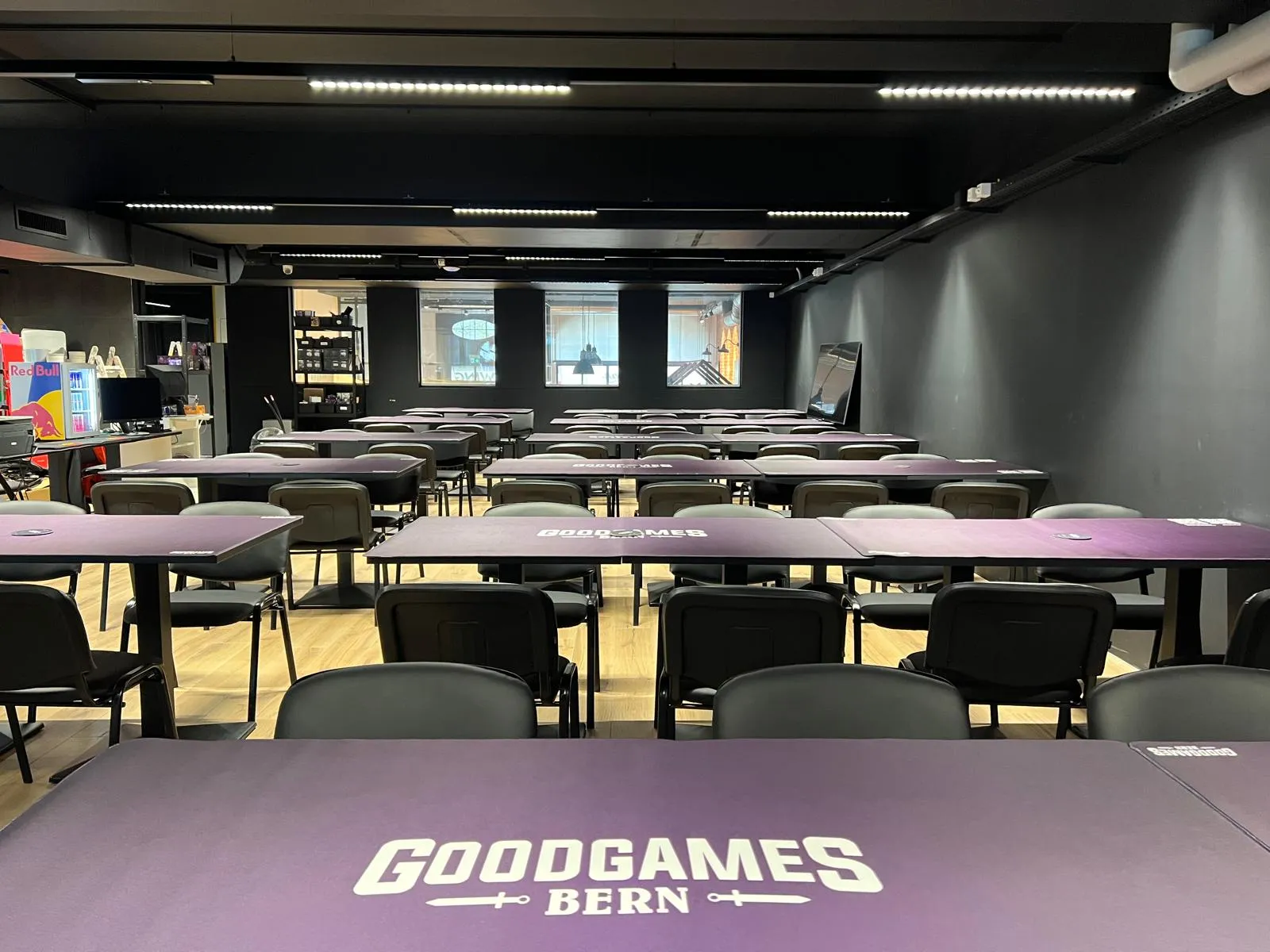 The tournament hall with rows of purple GoodGames Bern tables and chairs