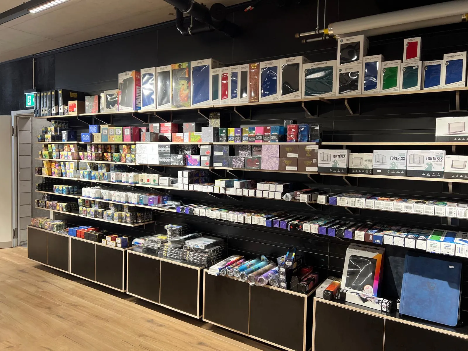 Accessory wall with sleeves, deck boxes, binders and playmats