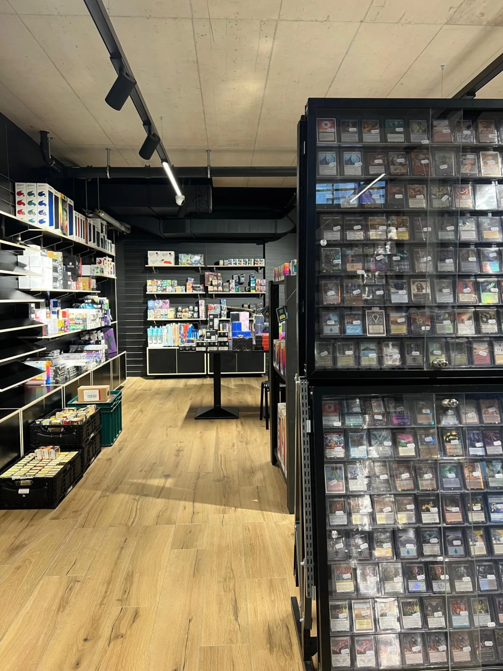 Aisle between the accessory shelves and a wall of single cards in top loaders