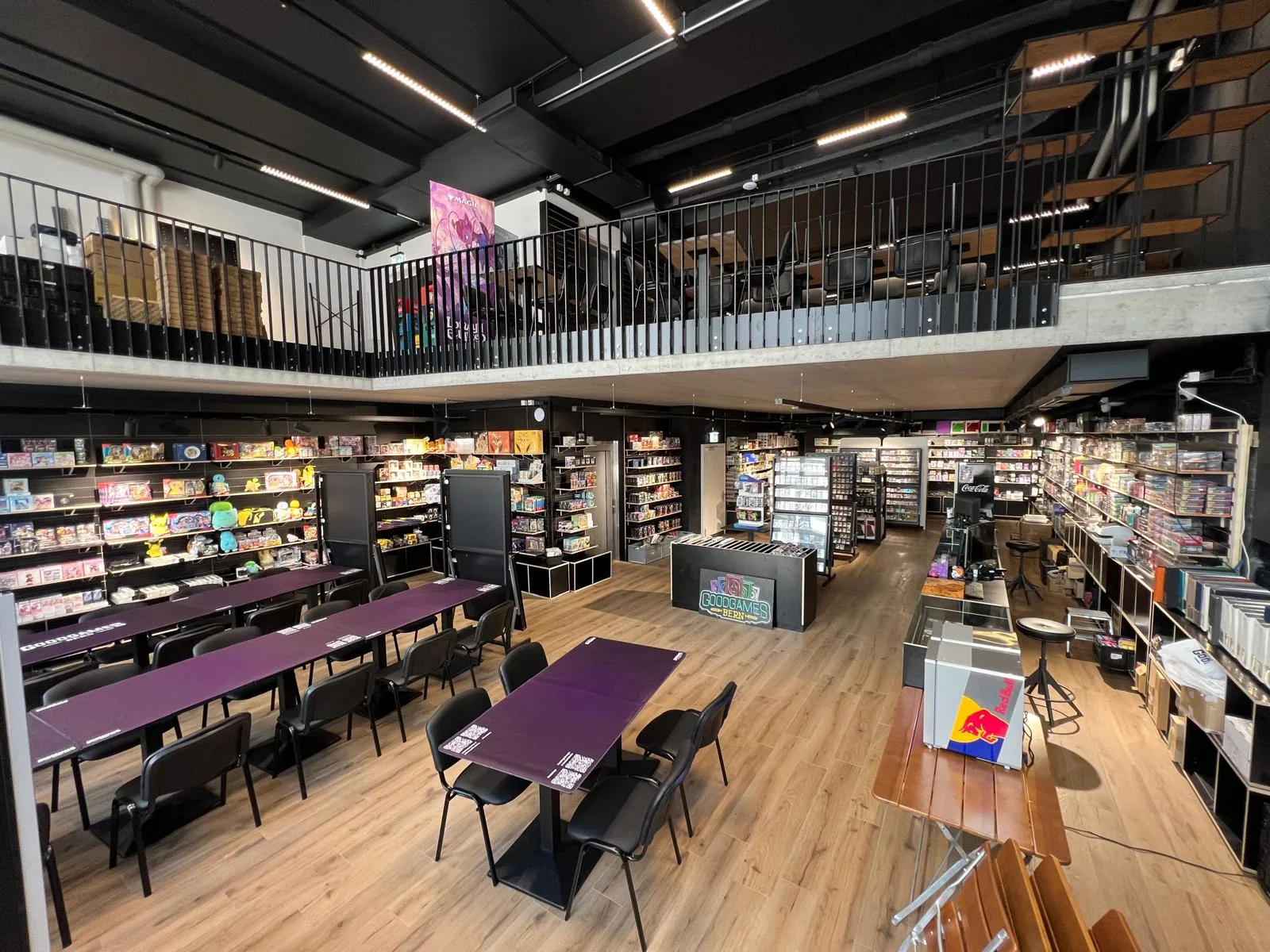 Wide shot of the shop floor and mezzanine with purple play tables and stocked shelves