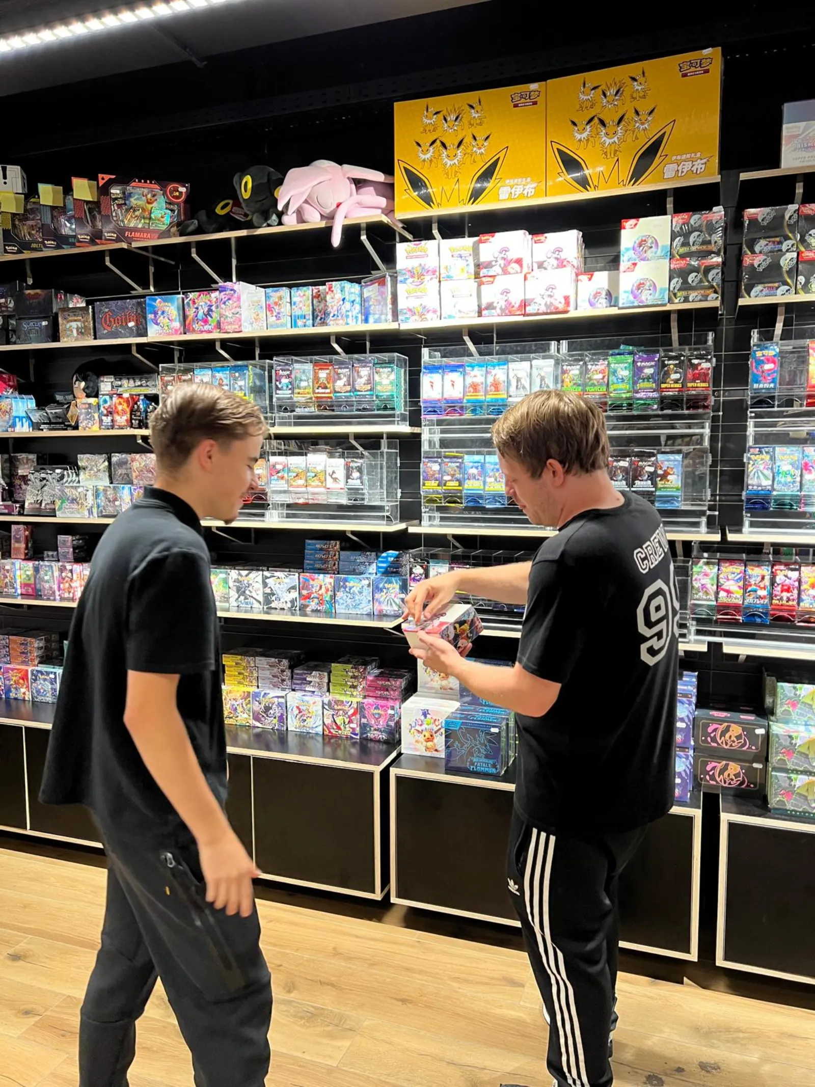 Customers browsing sealed products in the shop